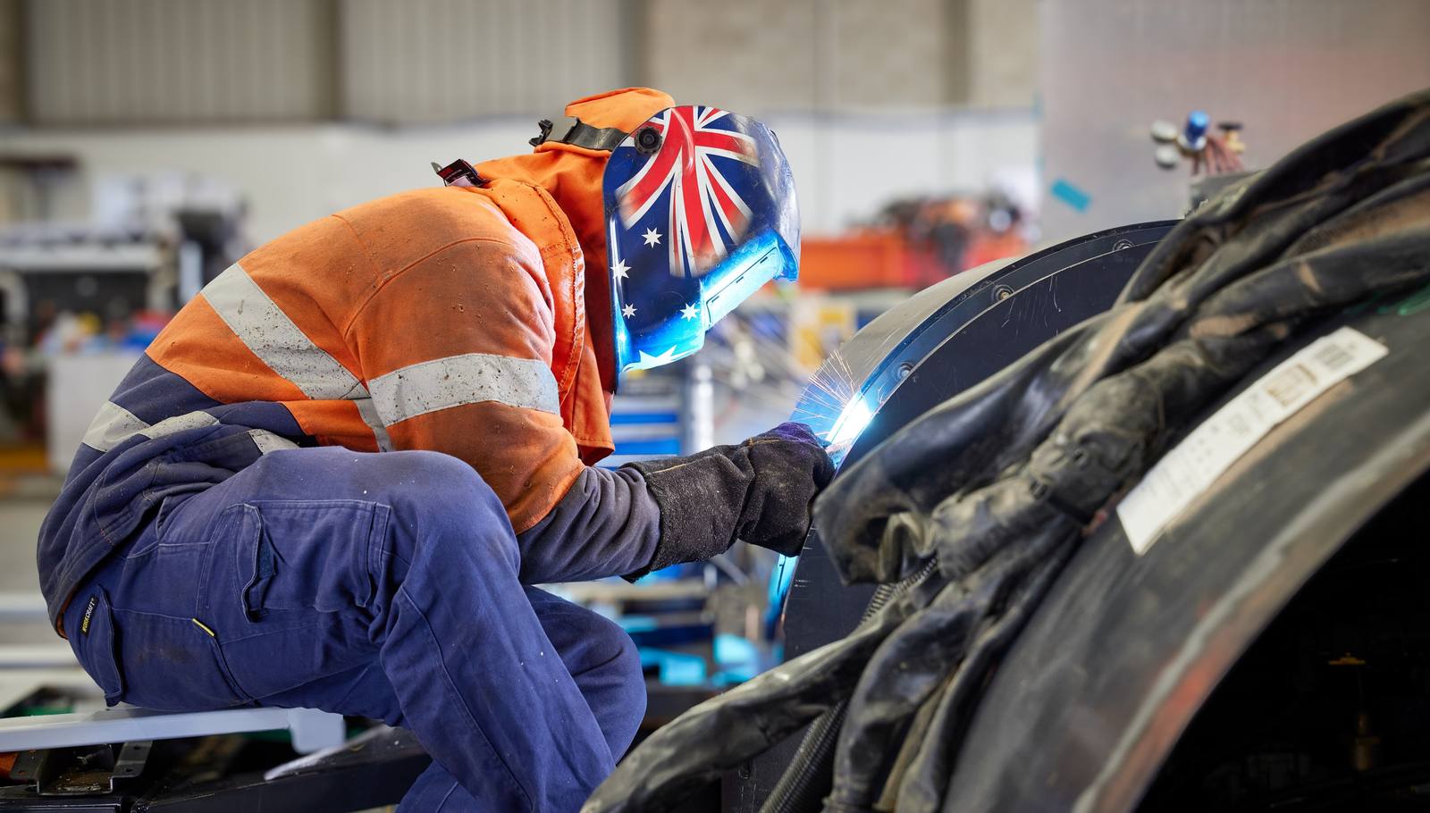 Volgren welder wearing an Australian flag helmet